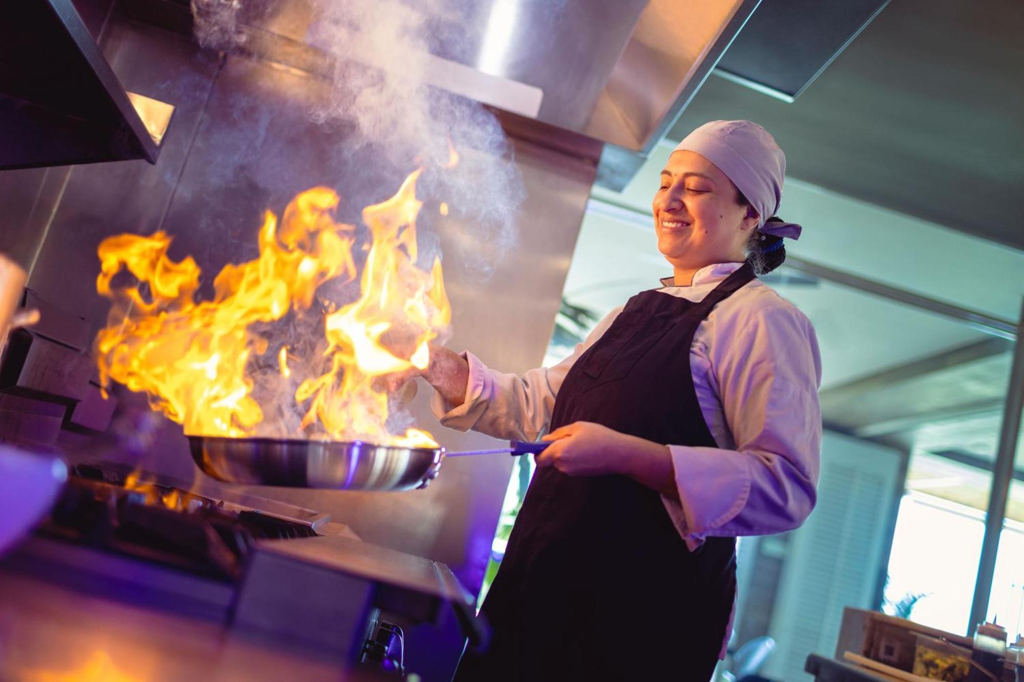 睡眠海滩圣玛尔塔万豪度假村 外观 照片 A chef cooking with a flaming skillet